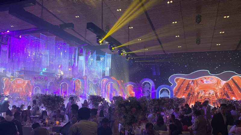 Guests gathered in front of a celebration stage with shaped LED scenic screens